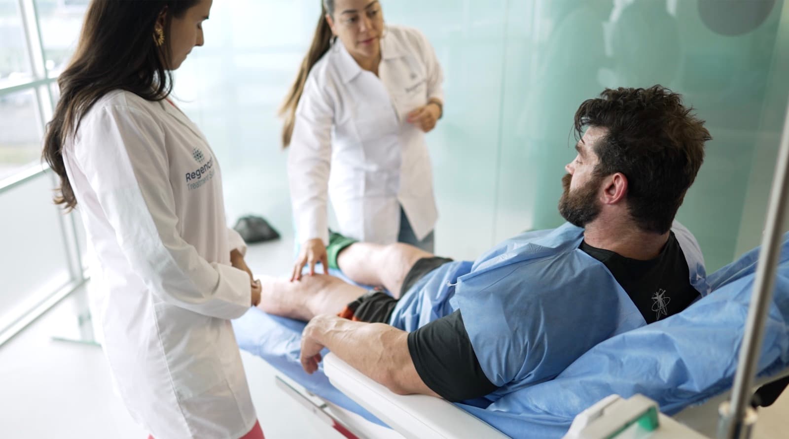 Brian Cage receiving a joint exam in the treatment suite